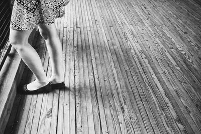 Low section of woman on hardwood floor