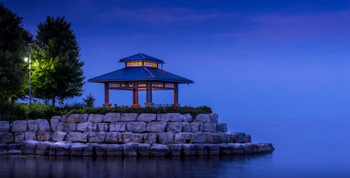 Illuminated gazebo at st lawrence park in lake ontario against sky