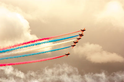 Low angle view of airshow against sky