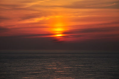 Scenic view of sea against romantic sky at sunset