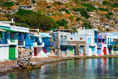 Multi colored houses by trees and buildings