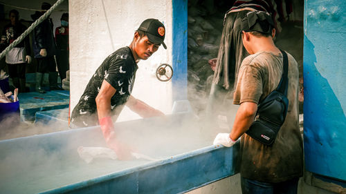 Young man working in water