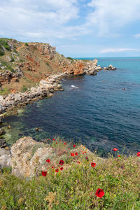 Scenic view of sea against cloudy sky