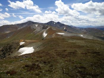 Scenic view of mountains against cloudy sky