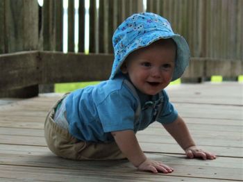 Cute boy in blue hat on boardwalk