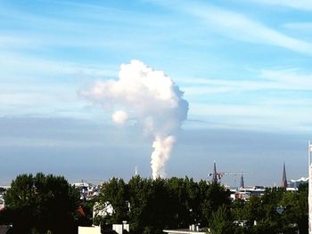 Smoke emitting from chimney against sky