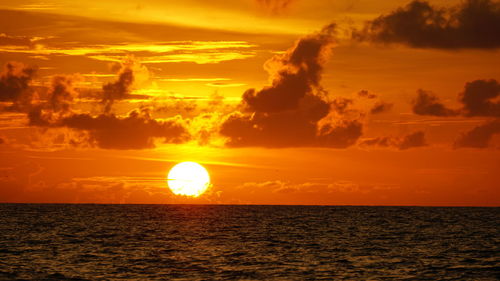 Scenic view of sea against orange sky