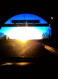 Road passing through sunset