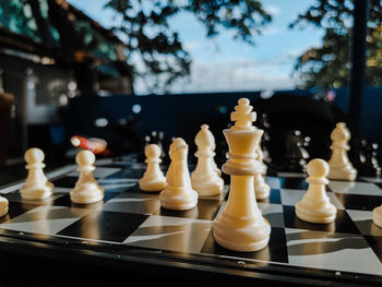 Chess pieces mid game under the sun