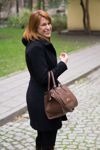 Young woman smiling while standing outdoors