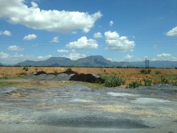 Scenic view of landscape against cloudy sky