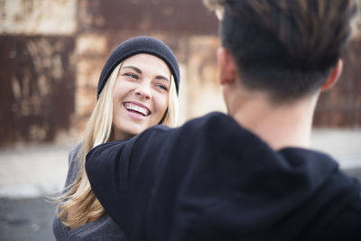 Portrait of smiling young woman wearing hat