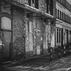 Old building by street in city at night