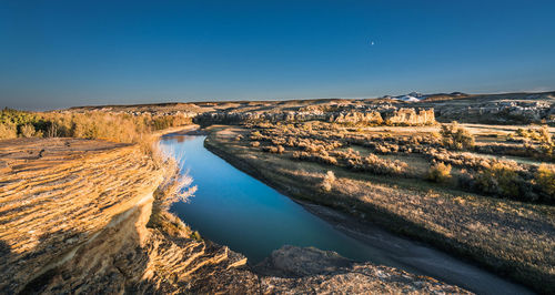 Panoramic view of landscape against clear blue sky