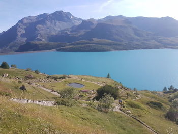 Scenic view of lake and mountains against sky