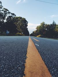 Surface level of empty country road along trees