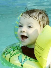 Close-up of cute boy in swimming pool