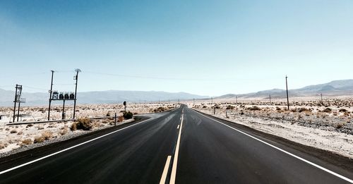 Empty road against clear sky