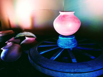 Close-up of illuminated electric lamp on table