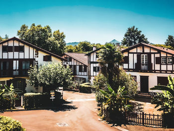 Houses and tree against buildings in town