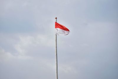 Low angle view of indonesian flag against sky