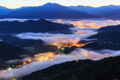 Scenic view of mountains against cloudy sky