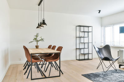 Empty chairs and table against wall at home