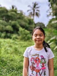 Portrait of a girl standing on field