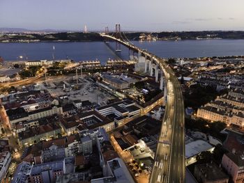 High angle view of illuminated city buildings against sky