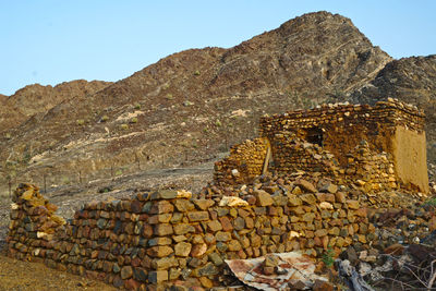 Stone wall with mountain range in background