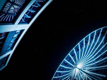 Low angle view of illuminated ferris wheel