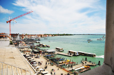 High angle view of city by sea against sky