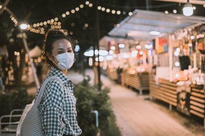 Series photo of young woman tourist wear surgical medical mask touring in street night market