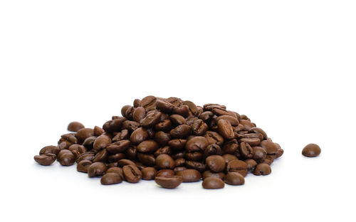 Close-up of coffee beans against white background