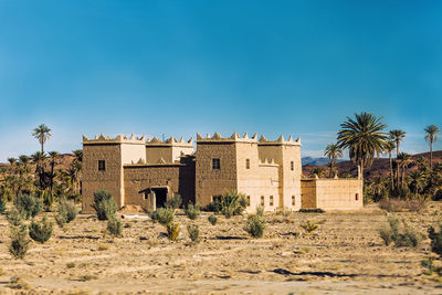 Berber traditional house with palm tree on sahara desert ouarzazate, morocco