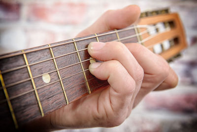 Cropped hand playing guitar