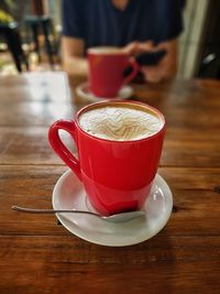 Close-up of cappuccino served on table