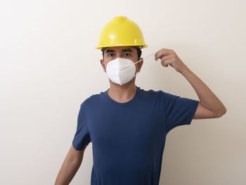 Portrait of man standing against white background