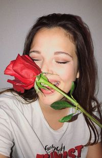 Close-up portrait of woman holding rose