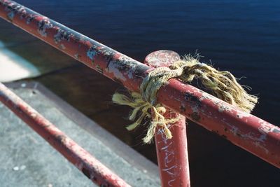 Close-up of rope tied on metal railing