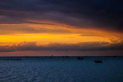 Scenic view of sea against orange sky