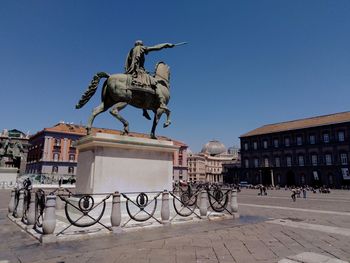 Bicycle statue against clear blue sky