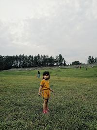 Full length of girl on field against sky