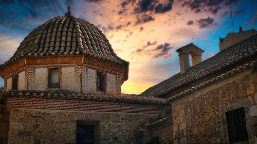 Low angle view of building against sky during sunset