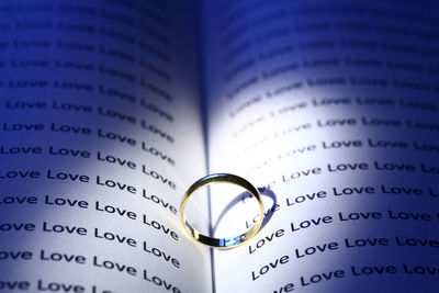 Close-up of ring on book with love text