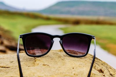 Close-up of sunglasses on water