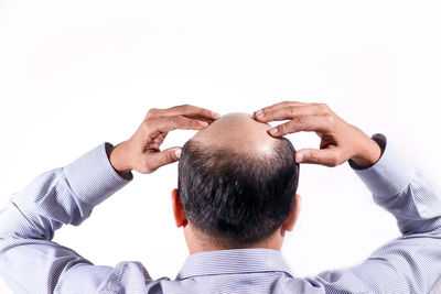 Rear view of man against white background