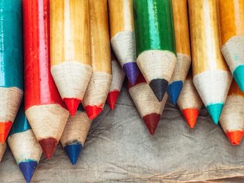 Close-up of colored pencils on fabric