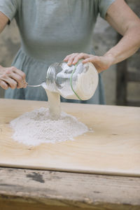 Midsection of man preparing food in kitchen