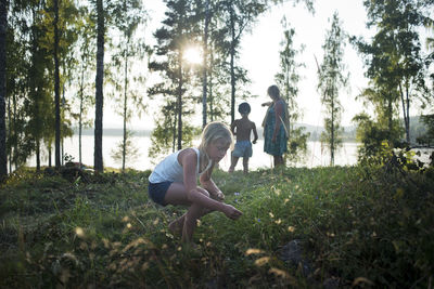 Family walking, girl picking flowers, dalarna, sweden